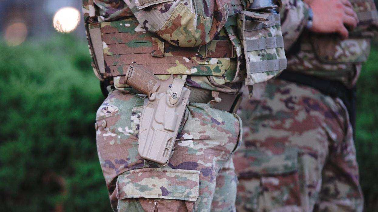 a military person wearing a uniform with a side arm