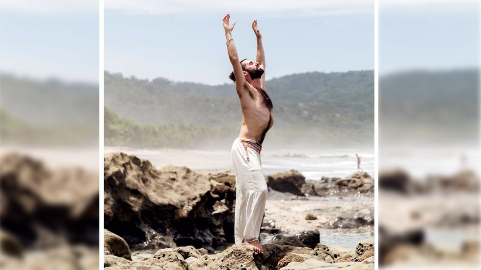 Activist and yoga expert Felice Marano streches on a rocky beach
