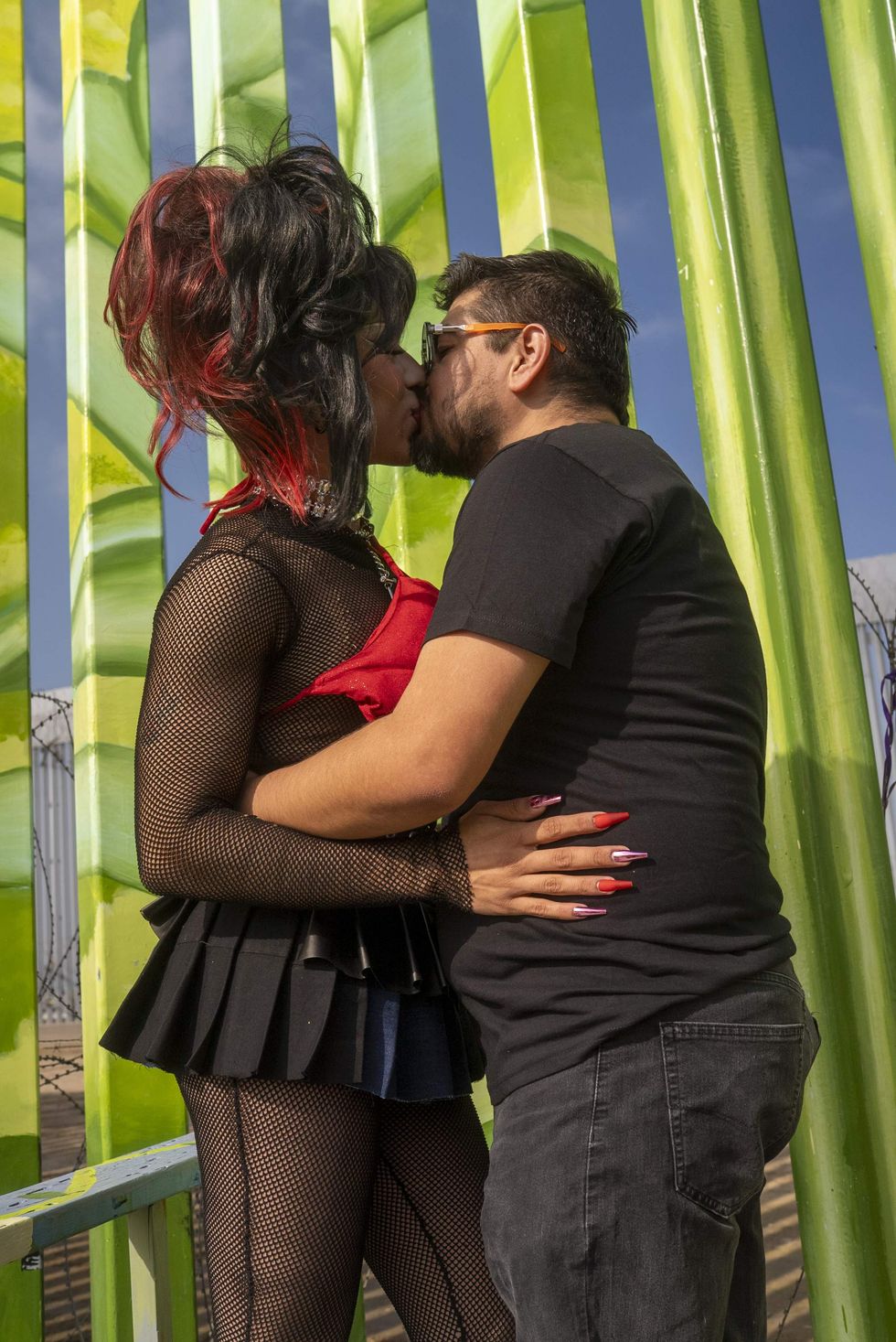 Man and drag queen kiss in front of U.S.-Mexico border