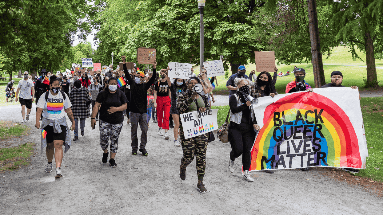 marchers hold signs that read black queer lives matter