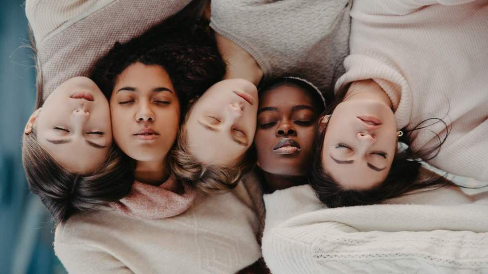 multi-ethnic group of young women looking serene with eyes closed