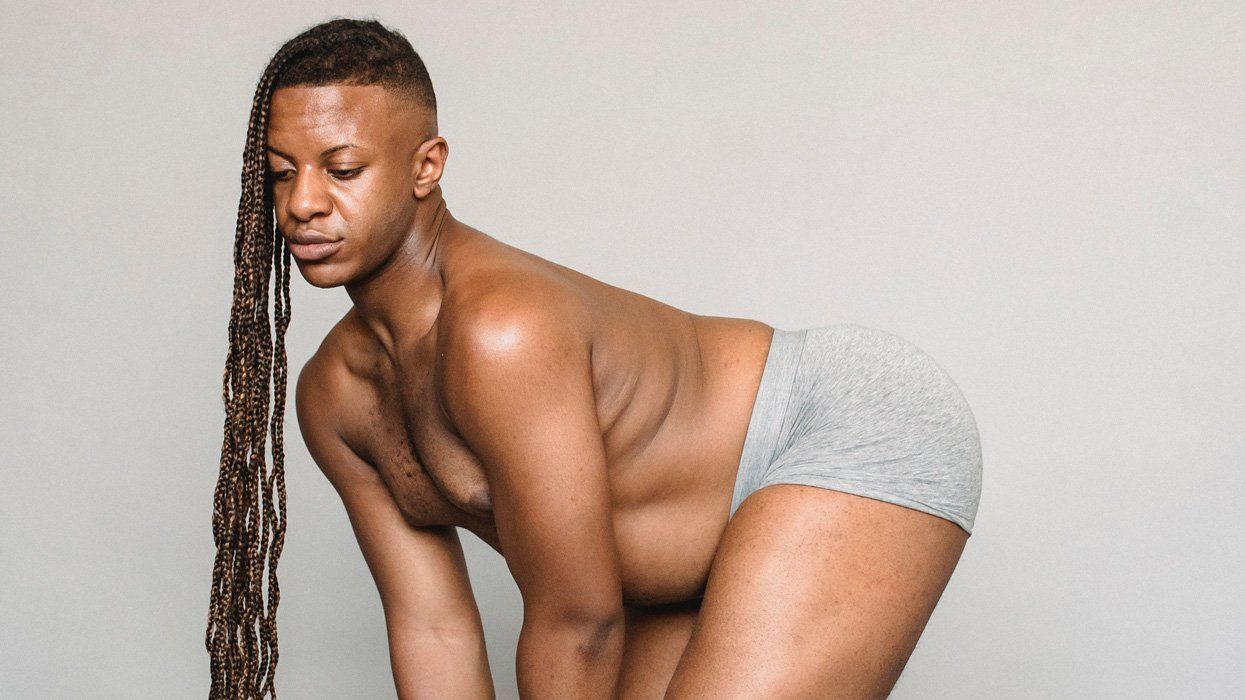 sexy black man with long hair in gray underwear