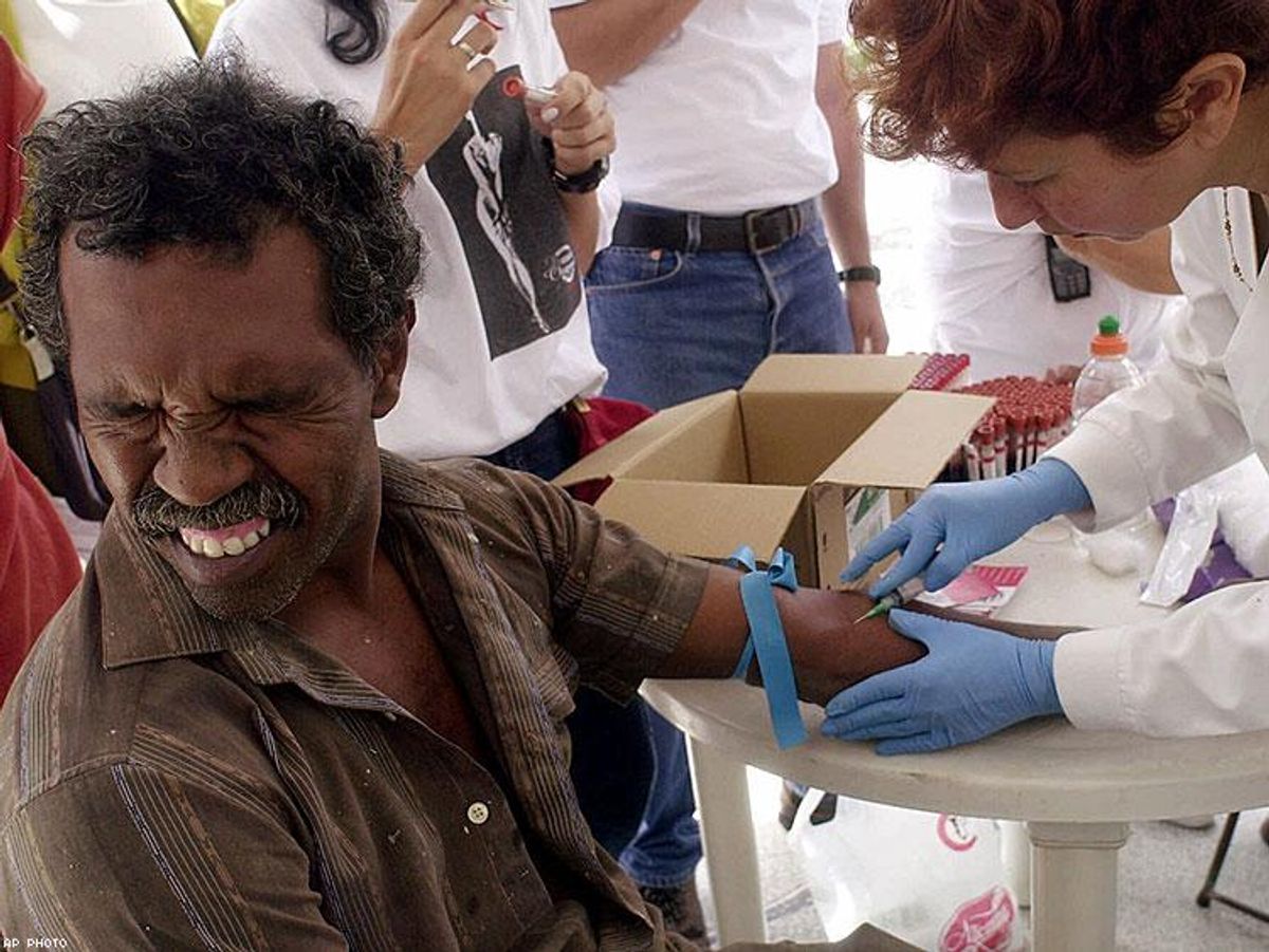 Venezuelan Julio Mantilla grimaces while a nurse draws blood to test for HIV.