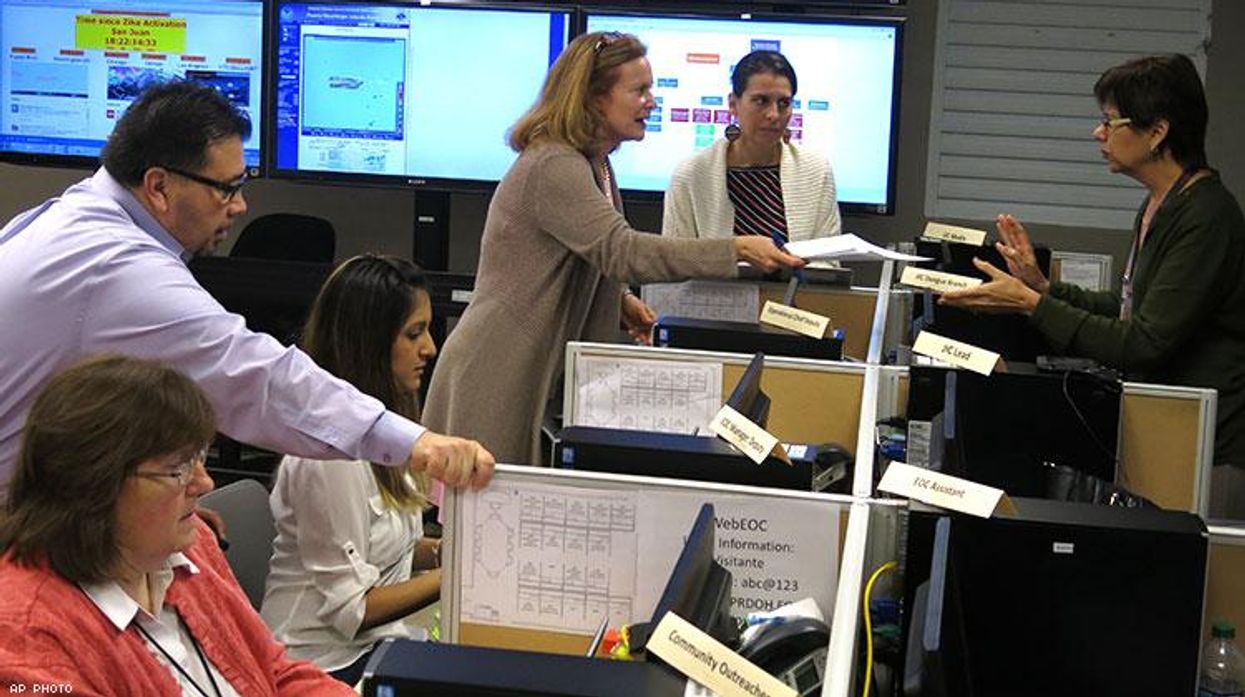 workers from the Puerto Rico Health Department and CDC review Zika related data collected by the island's health department and the U.S. Centers for Disease Control.