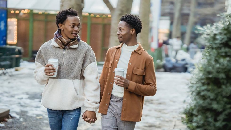 Young Black couple holding hands and walking in cold weather