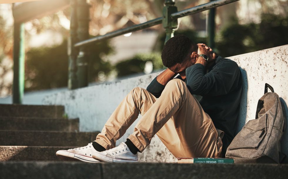 Young man sitting on the ground