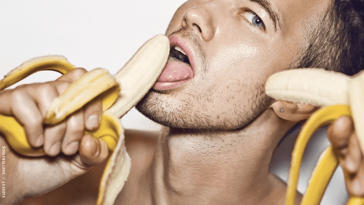 a man with bananas near his mouth and face